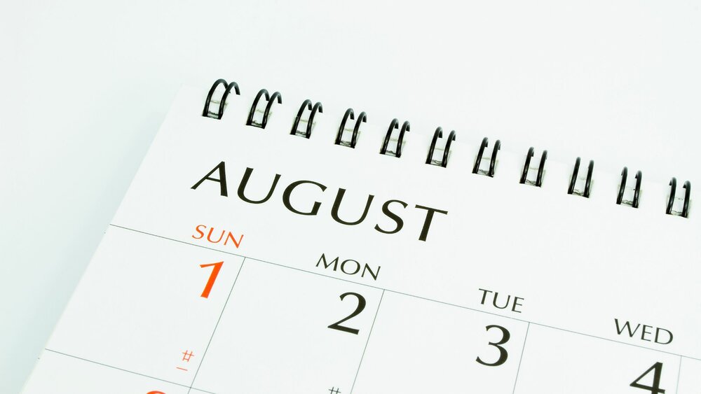 August calendar open on a desk